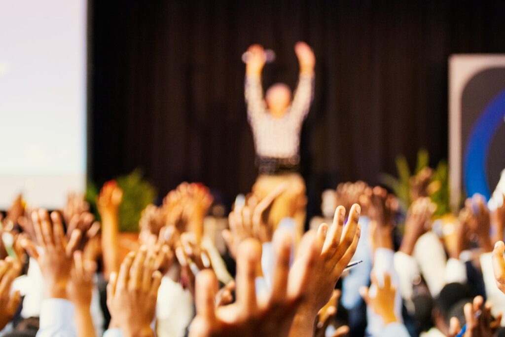 Image of person talking in a crowd about the benefits of blogging. 